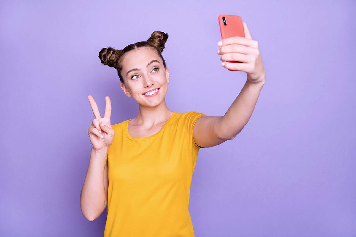 Girl taking selfie with smartphone